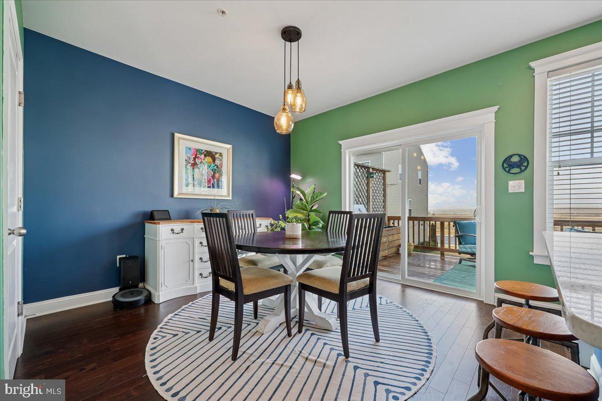 6501 Britannic Place Frederick, MD 21703 - Photo 22 of 64 a dining room with furniture a chandelier and wooden floor