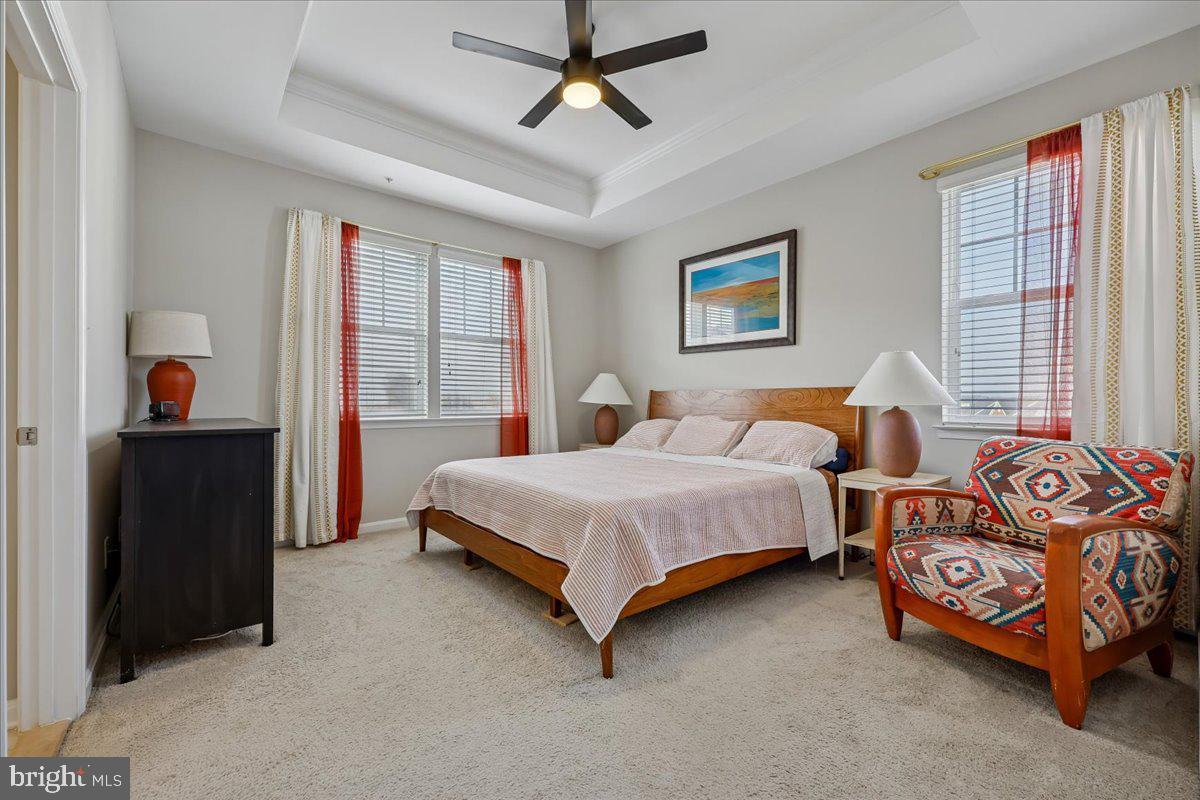 6501 Britannic Place Frederick, MD 21703 - Photo 33 of 64 a bedroom with two beds and a chandelier