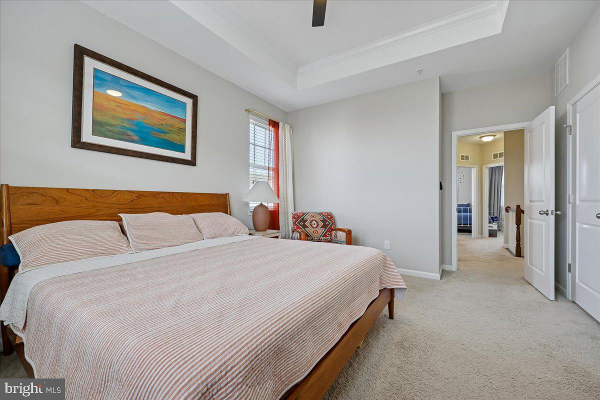 6501 Britannic Place Frederick, MD 21703 - Photo 34 of 64 a bedroom with a bed and a painting on the wall