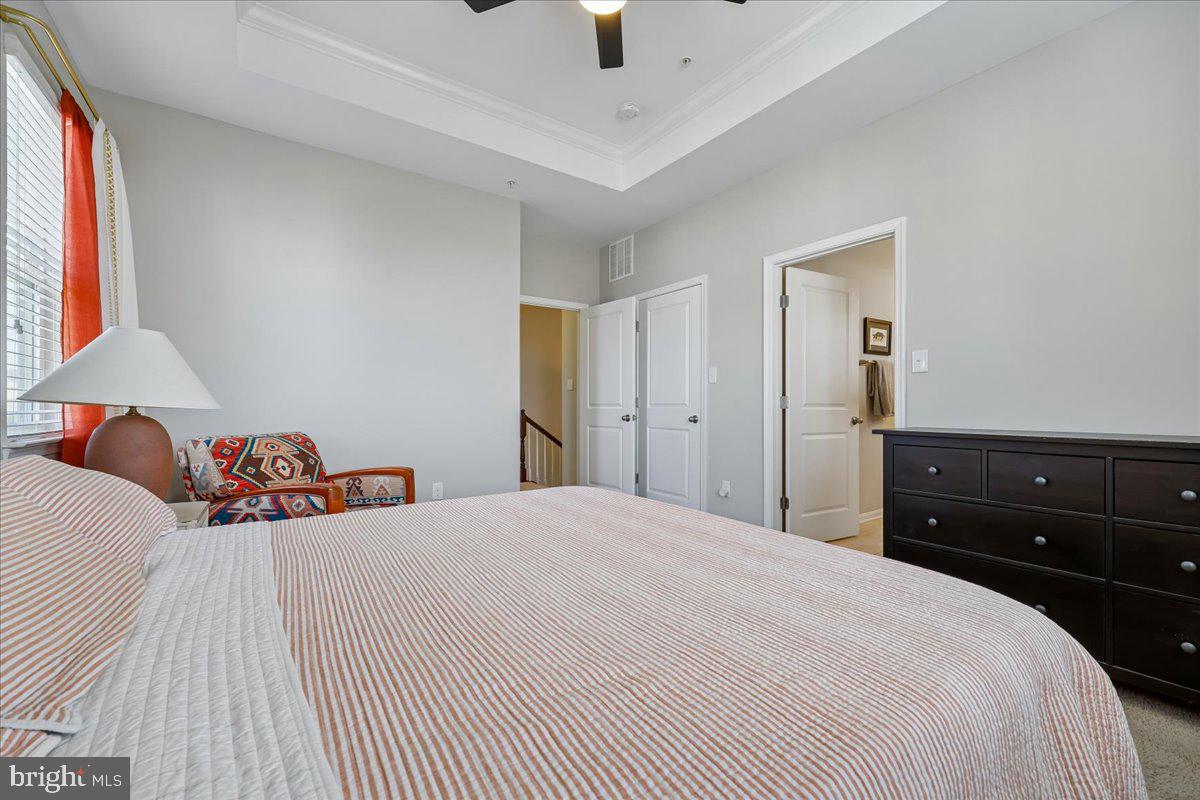 6501 Britannic Place Frederick, MD 21703 - Photo 35 of 64 a bedroom with a bed and a chandelier