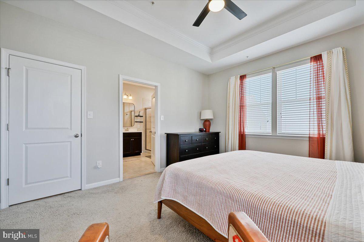 6501 Britannic Place Frederick, MD 21703 - Photo 36 of 64 a bedroom with a bed and a chandelier