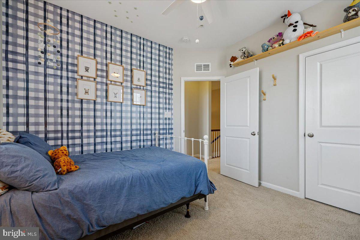 6501 Britannic Place Frederick, MD 21703 - Photo 40 of 64 a bedroom with a bed and a table in it