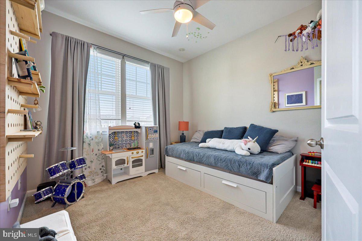 6501 Britannic Place Frederick, MD 21703 - Photo 41 of 64 a bedroom with a bed and a chandelier