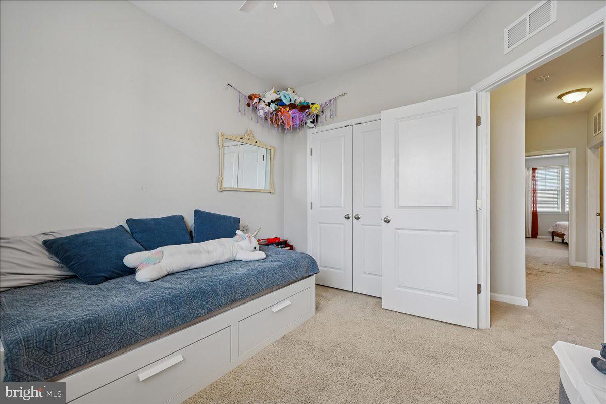 6501 Britannic Place Frederick, MD 21703 - Photo 43 of 64 a bedroom with a bed and a chandelier