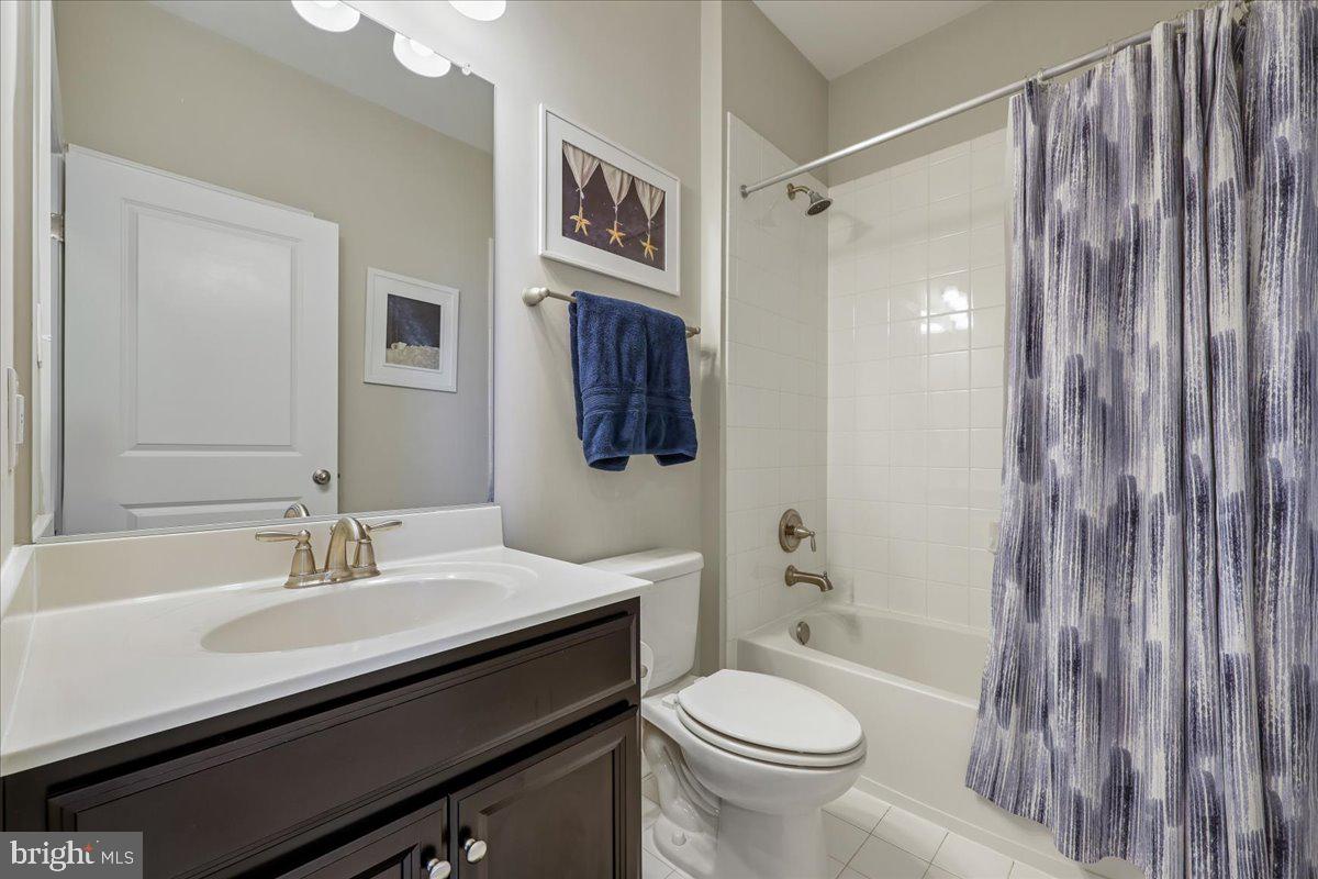 6501 Britannic Place Frederick, MD 21703 - Photo 44 of 64 a bathroom with a sink a toilet a mirror and shower