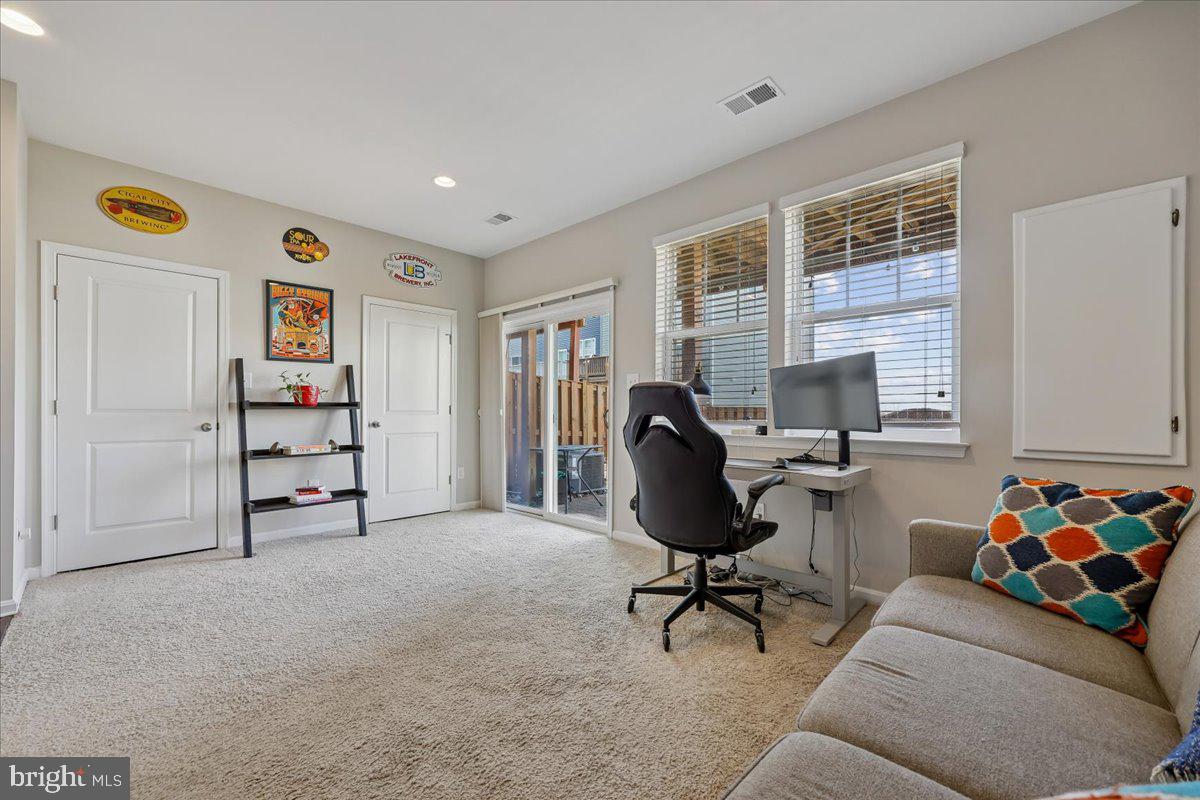 6501 Britannic Place Frederick, MD 21703 - Photo 47 of 64 a livingroom with workspace and a couch