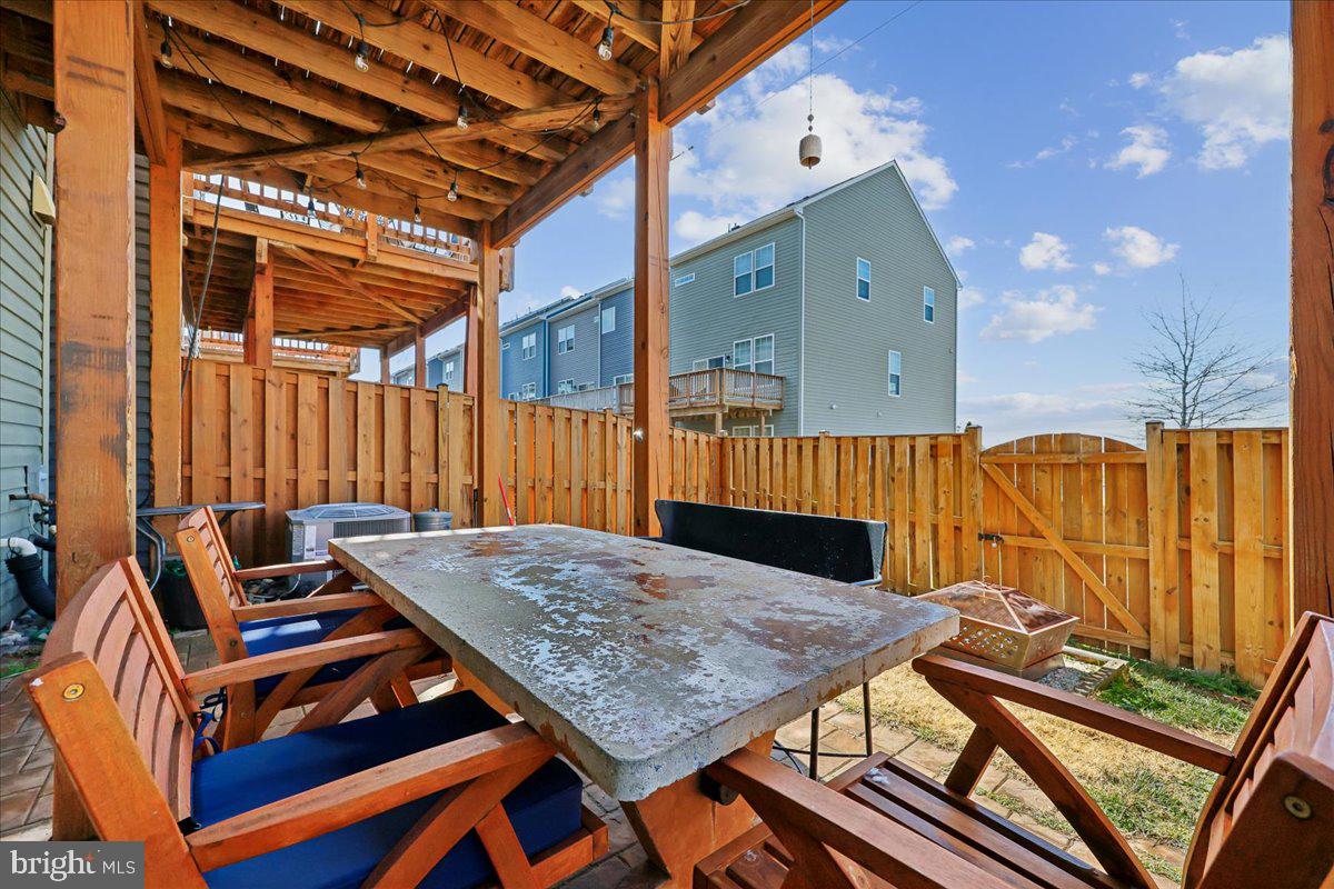 6501 Britannic Place Frederick, MD 21703 - Photo 50 of 64 a roof deck with table and chairs with wooden floor