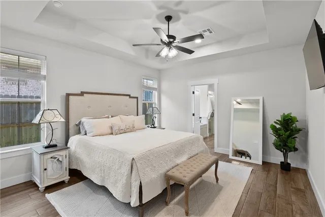 a bedroom with a bed and a chandelier