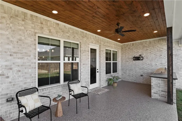 a view of a patio with table and chairs and potted plants