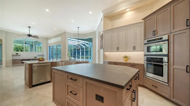 a bathroom with a double vanity sink a large mirror and a bathtub