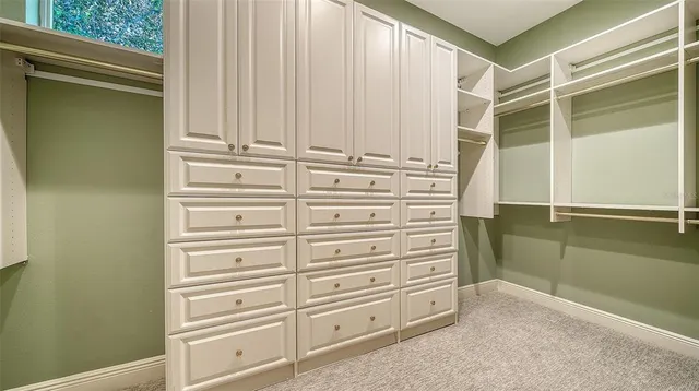 a utility room with cabinets washer and dryer