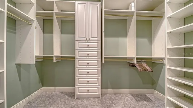 a view of a backyard with floor to ceiling windows and potted plants