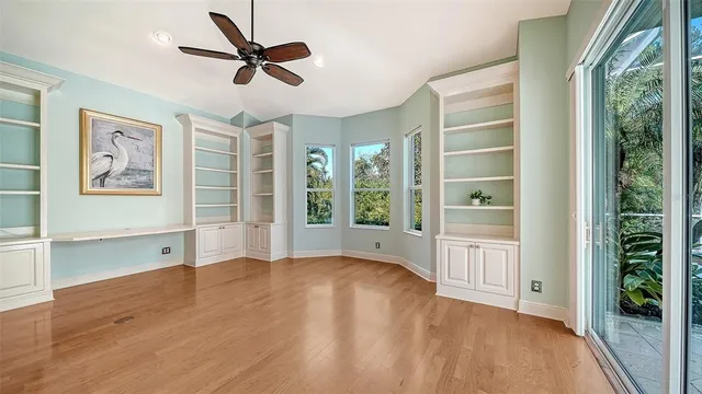 an aerial view of residential houses with outdoor space and trees