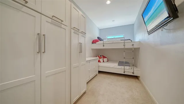 a front view of a house with garden and sitting area