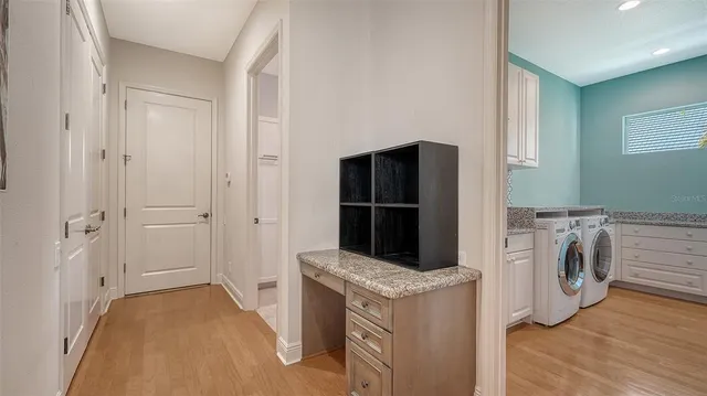 a dining hall with stainless steel appliances kitchen island granite countertop a table and chairs