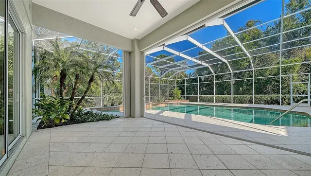 a view of a tennis ground with large trees