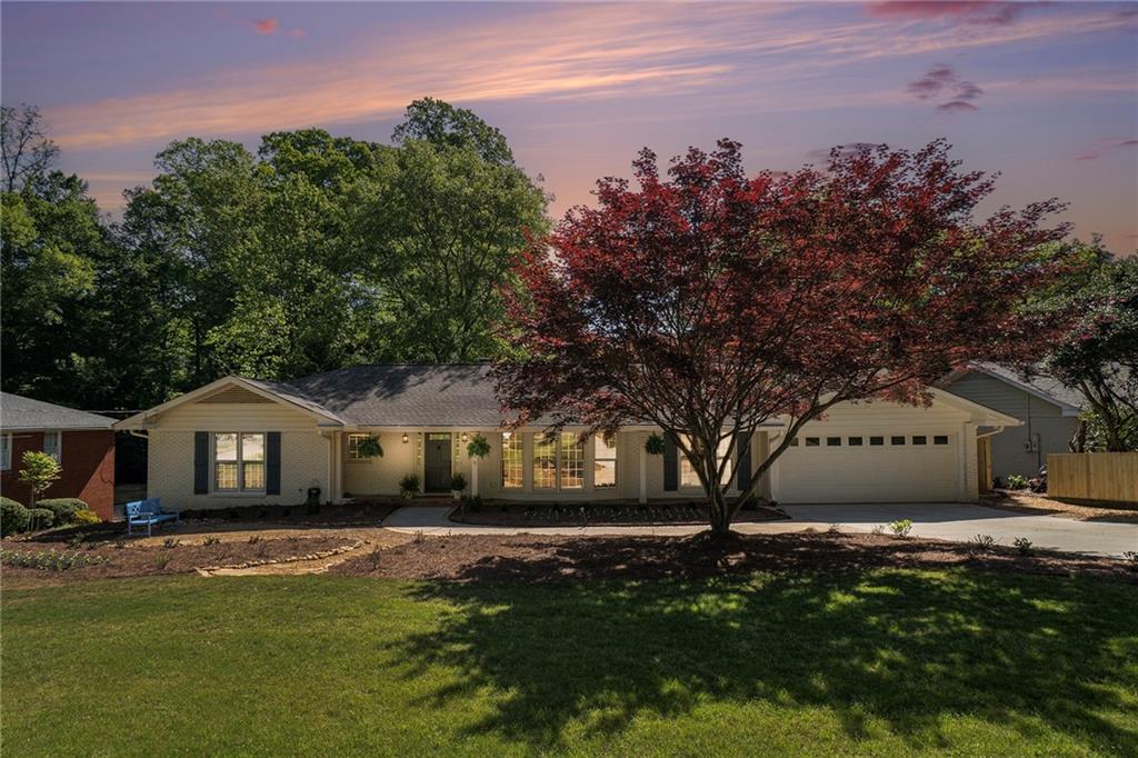 a front view of a house with a garden