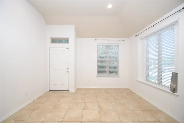 an empty room with windows and entrance