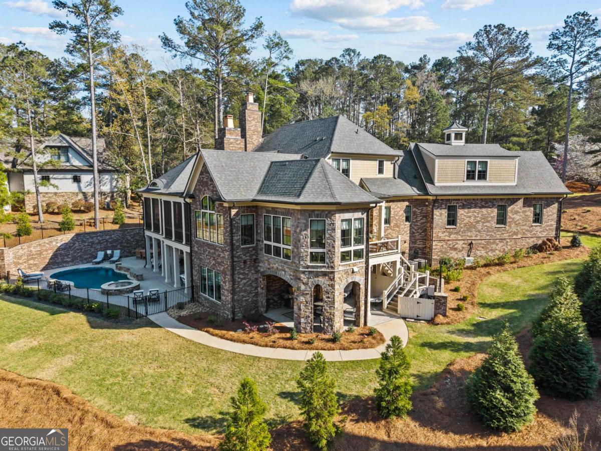5010 Browns Ford Road Greensboro, GA 30642 - Photo 11 of 67 a aerial view of a house with swimming pool and large trees