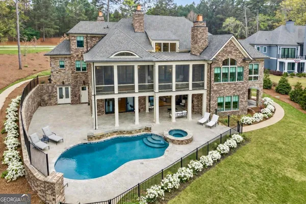 a swimming pool with outdoor seating and yard
