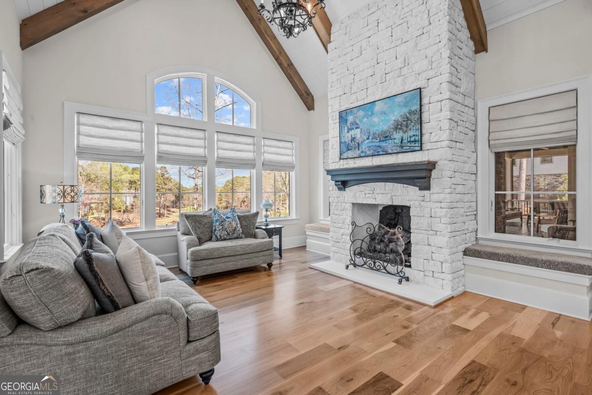 5010 Browns Ford Road Greensboro, GA 30642 - Photo 32 of 67 a living room with furniture a large window and a fireplace