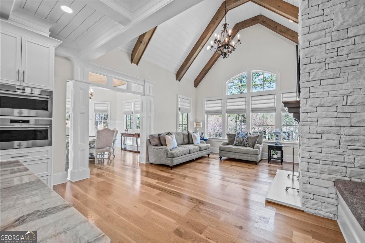 5010 Browns Ford Road Greensboro, GA 30642 - Photo 33 of 67 a living room with fireplace furniture and a chandelier
