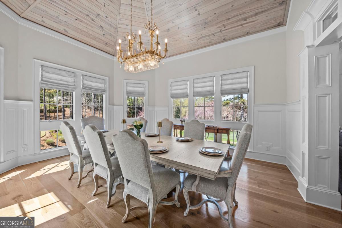 5010 Browns Ford Road Greensboro, GA 30642 - Photo 34 of 67 a view of a dining room with furniture a chandelier and wooden floor