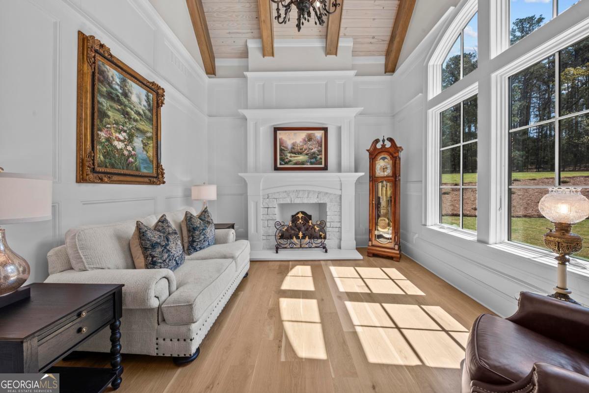 5010 Browns Ford Road Greensboro, GA 30642 - Photo 36 of 67 a living room with furniture a fireplace and a floor to ceiling window