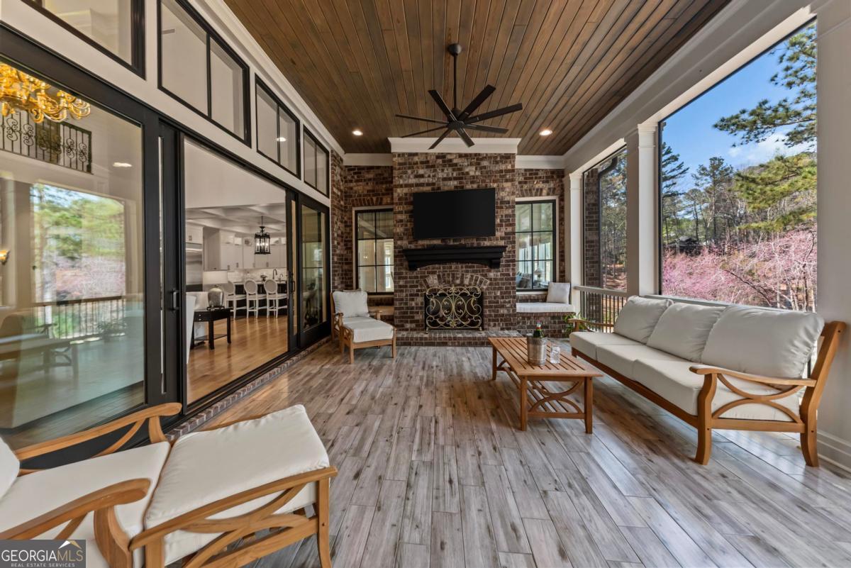 5010 Browns Ford Road Greensboro, GA 30642 - Photo 40 of 67 a living room with furniture a flat screen tv and a floor to ceiling window