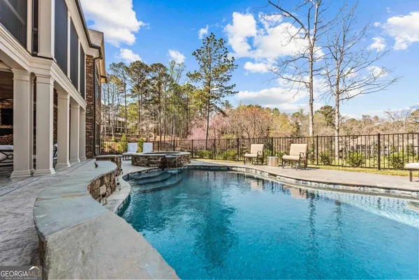 a view of a swimming pool with outdoor seating