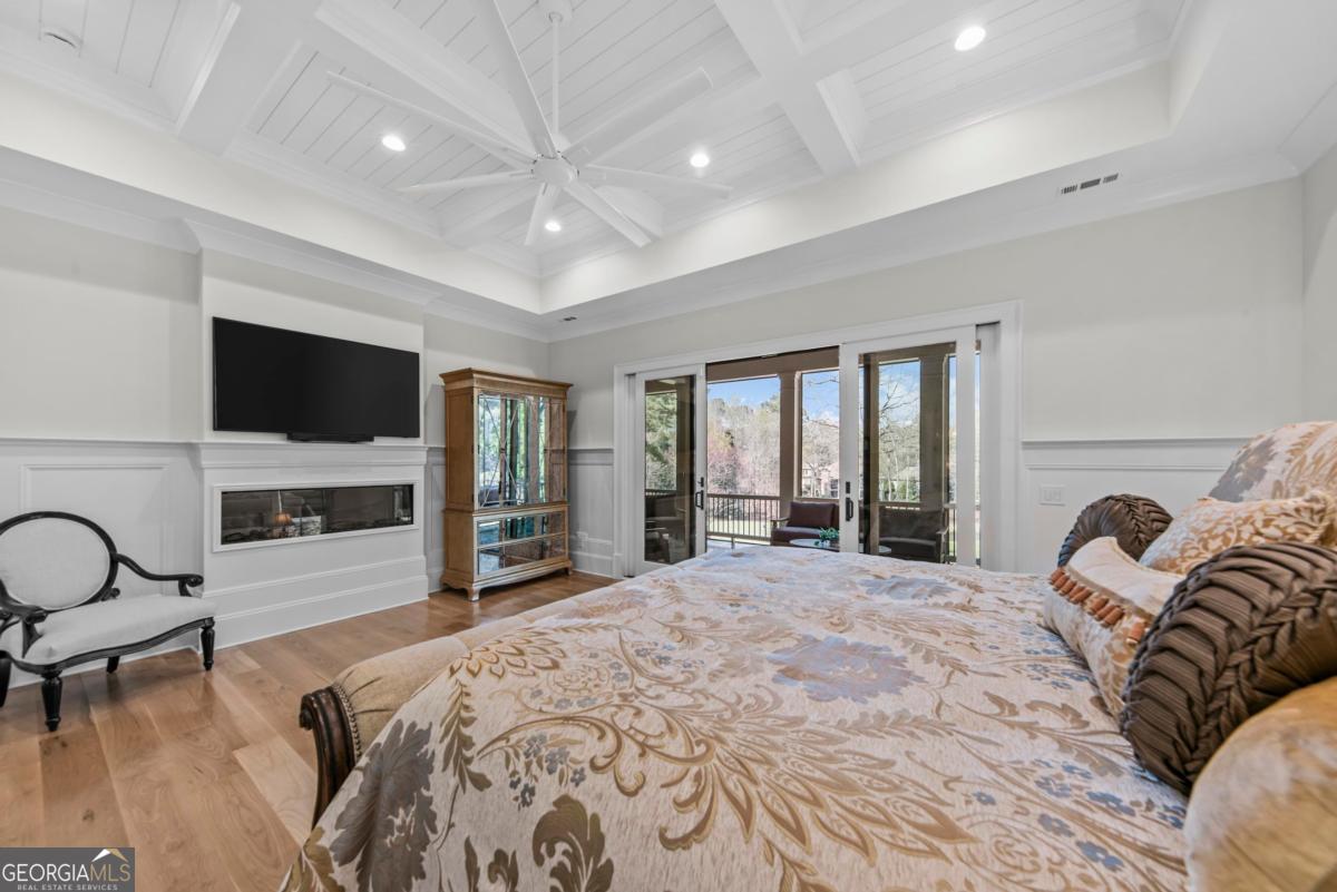 5010 Browns Ford Road Greensboro, GA 30642 - Photo 44 of 67 a large bedroom with a bed and a flat tv screen on the dresser