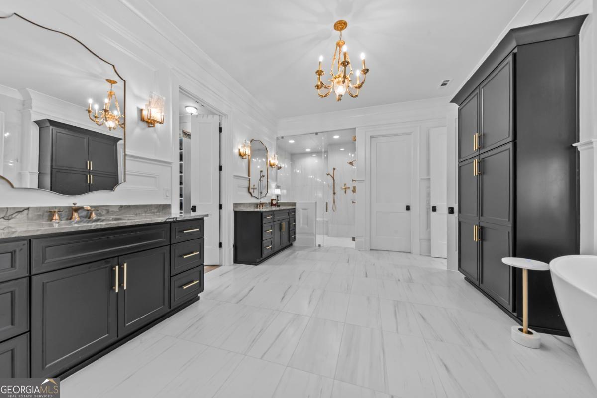 5010 Browns Ford Road Greensboro, GA 30642 - Photo 46 of 67 a spacious bathroom with a granite countertop sink a large mirror a shower and a bathtub