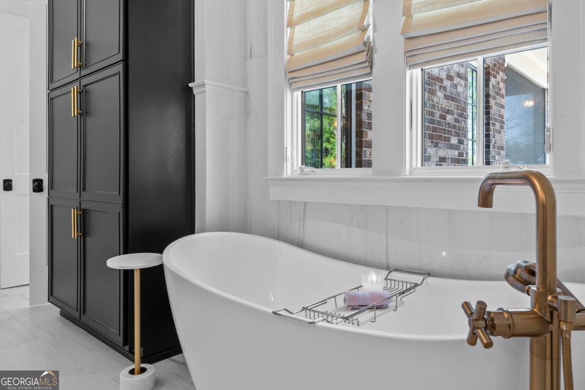 5010 Browns Ford Road Greensboro, GA 30642 - Photo 47 of 67 a bath tub sitting in a bathroom next to a window