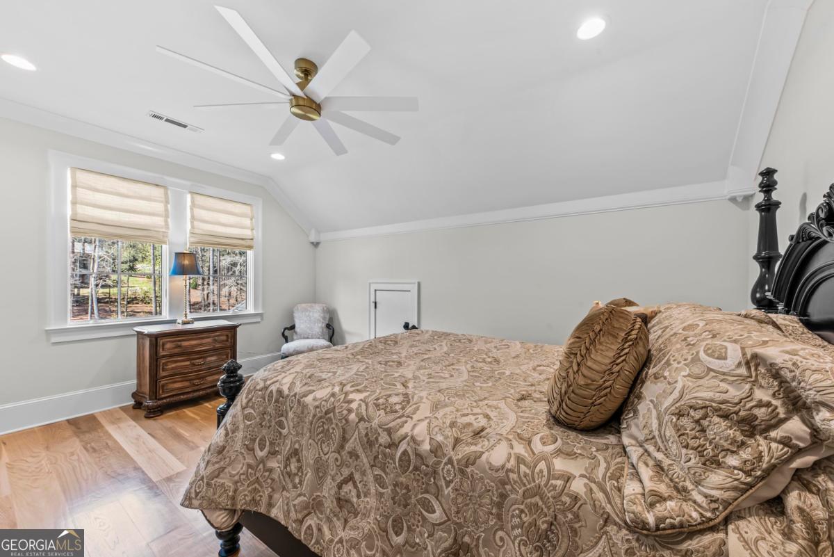 5010 Browns Ford Road Greensboro, GA 30642 - Photo 52 of 67 a bedroom with a bed and a dresser next to a window