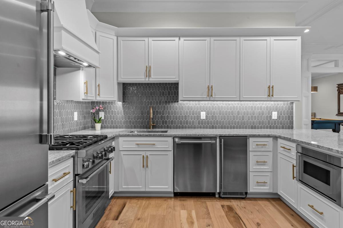 5010 Browns Ford Road Greensboro, GA 30642 - Photo 63 of 67 a kitchen with cabinets appliances and a wooden floor