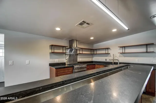 a kitchen with stainless steel appliances a sink and cabinets