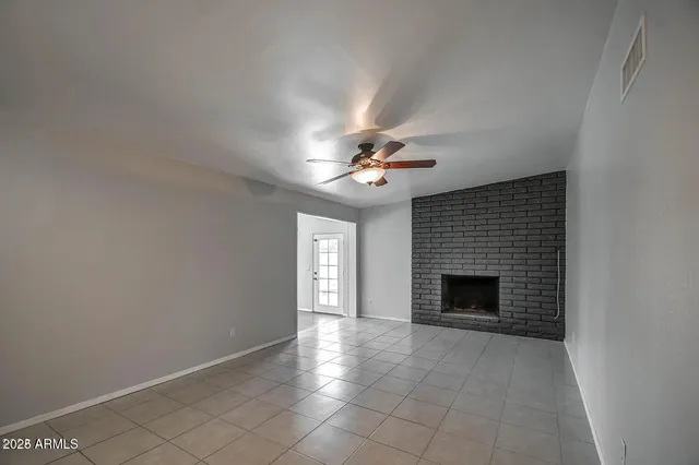 a view of an empty room with a fireplace