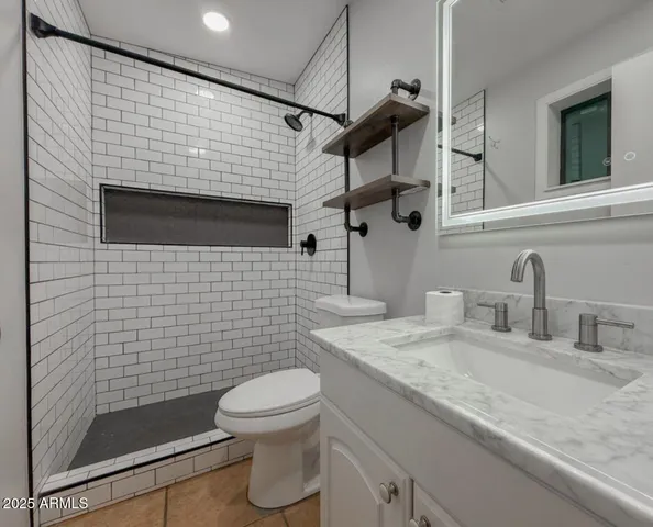 a view of a room with a ceiling fan and window