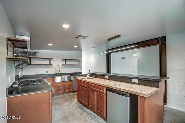 a kitchen with stainless steel appliances granite countertop a sink and cabinets