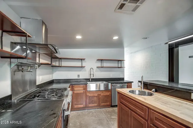 a kitchen that has a sink and a stove in it