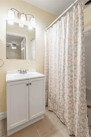a bathroom with a sink vanity and a mirror