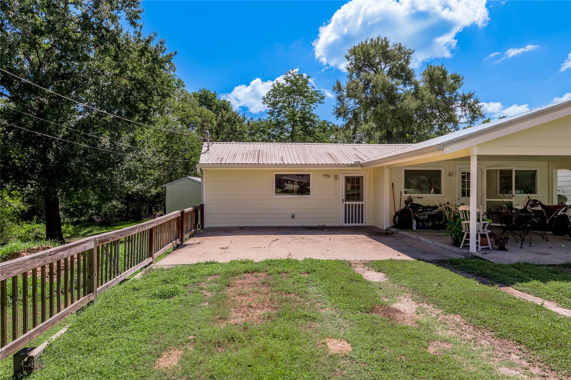 4 Rainbow Drive, Unit A Huntsville, TX 77320 - Photo 2 of 15 a view of a backyard with table and chairs and wooden fence