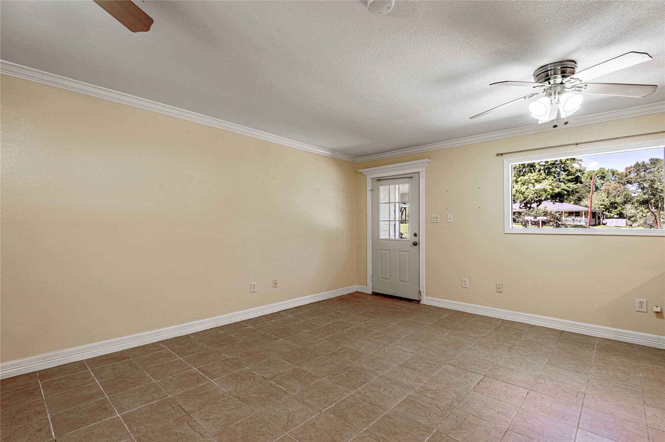 4 Rainbow Drive, Unit A Huntsville, TX 77320 - Photo 6 of 15 a view of an empty room with a chandelier fan