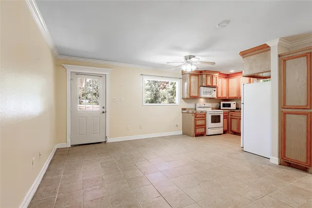 a view of a kitchen with refrigerator and windows