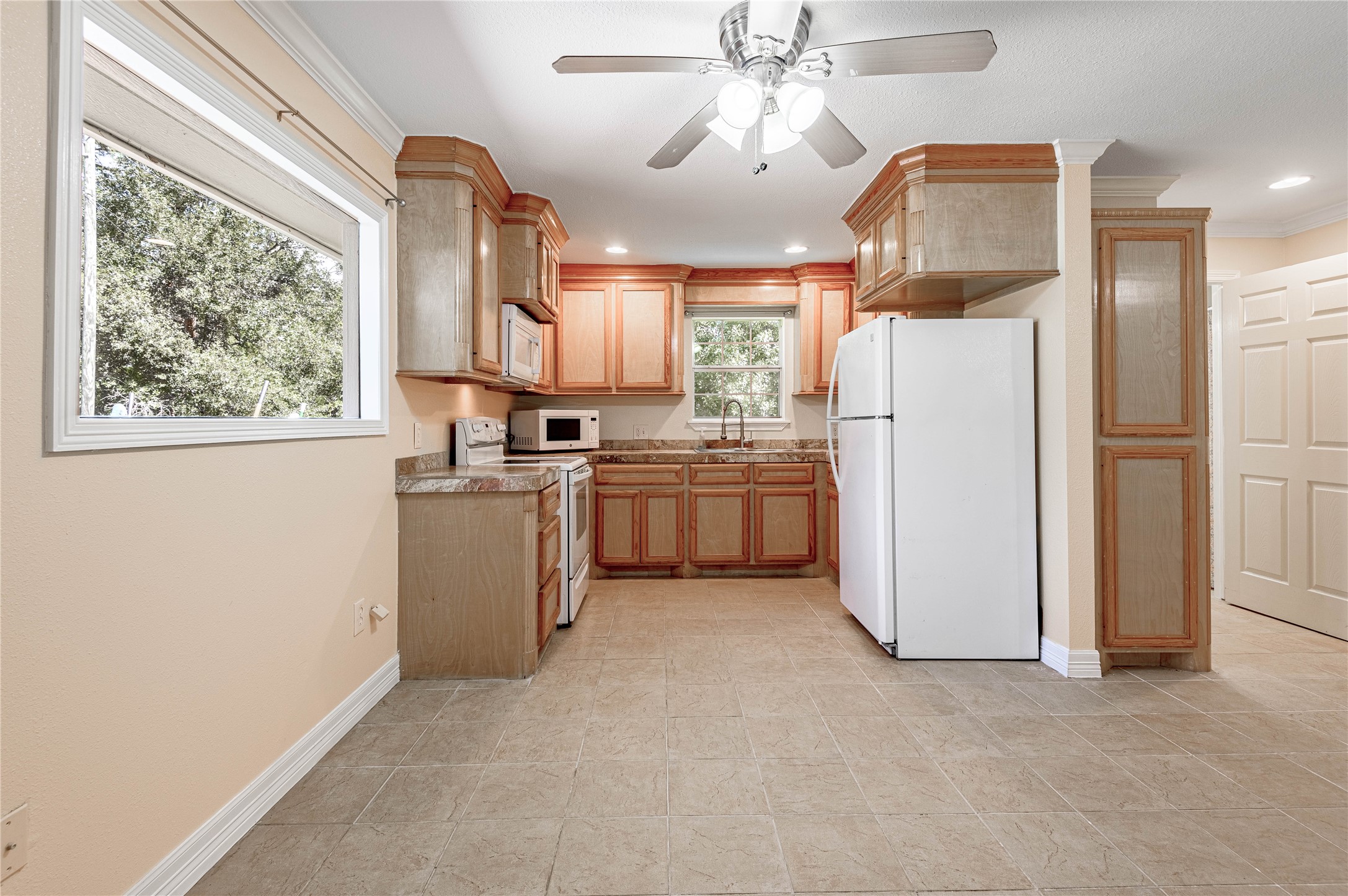 4 Rainbow Drive, Unit A Huntsville, TX 77320 - Photo 8 of 15 a kitchen with a refrigerator a sink and dishwasher a stove top oven