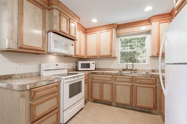 a kitchen with stainless steel appliances granite countertop a sink and cabinets
