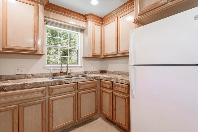 a kitchen with stainless steel appliances granite countertop a sink and a window