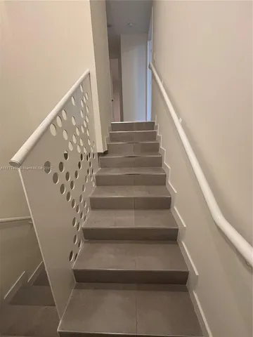 a view of hallway with furniture and a window