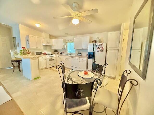 51555 Monroe Street, Unit 101 Indio, CA 92201 - Photo 9 of 18 a room with stainless steel appliances kitchen island granite countertop furniture and a kitchen view