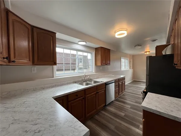 a large kitchen with stainless steel appliances granite countertop a sink stove and refrigerator